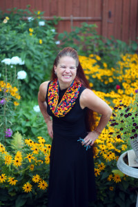 Smiling model wearing kapow Cowl in a garden