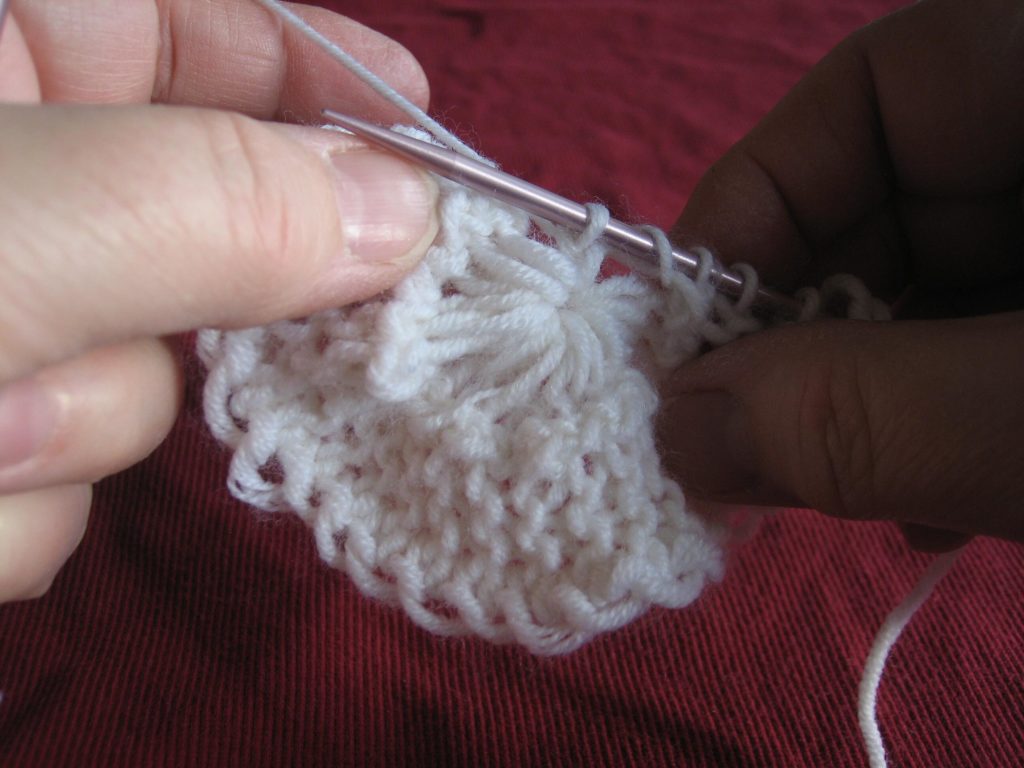 Slip that stitch back on the needle and knit it again