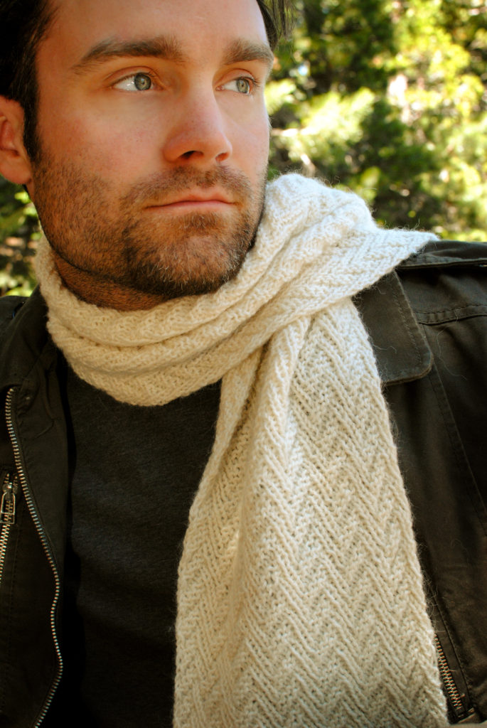 Andrew wearing a white herringbone parallelogram scarf