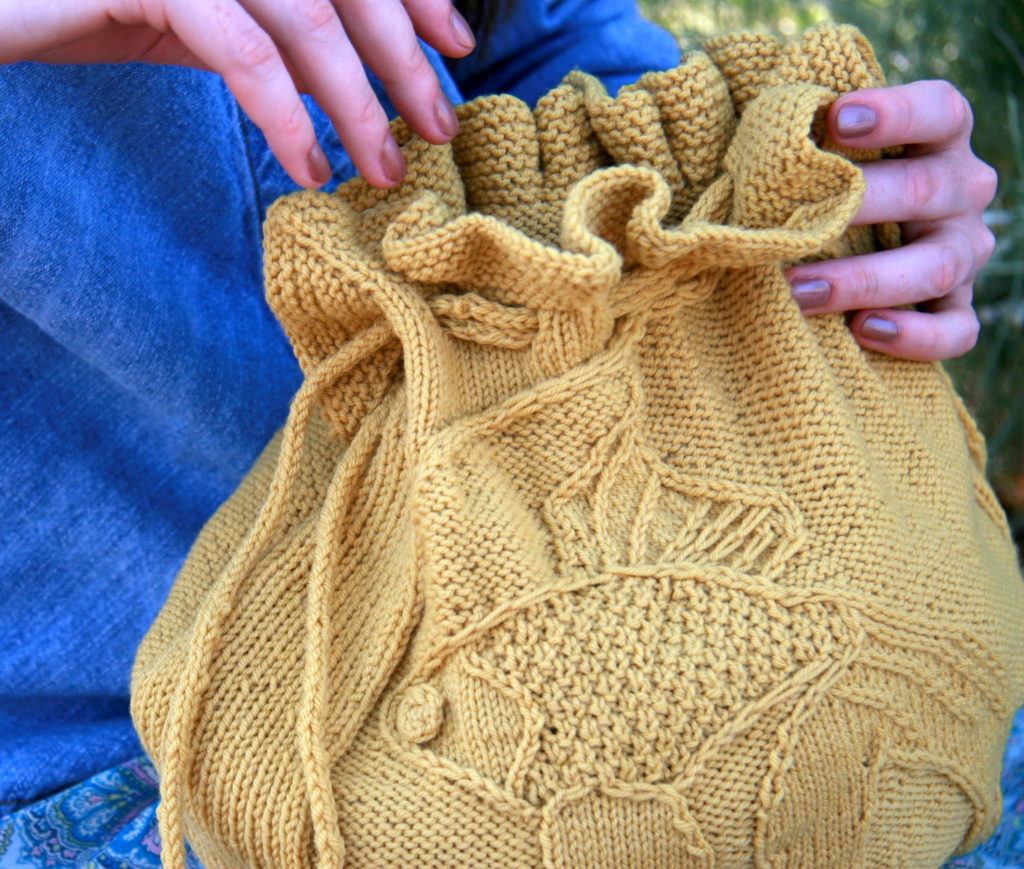 Yellow knitted bag with goldfish decoration