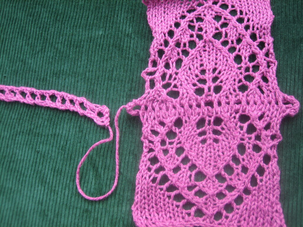 Ladder Braid shown with a lace swatch in which the motif is mirrored because both sides were picked up and knit into ladder braid