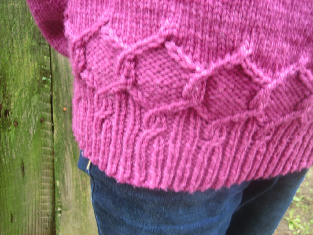 Hem of Alcyone Sweater showing decorative hexagon