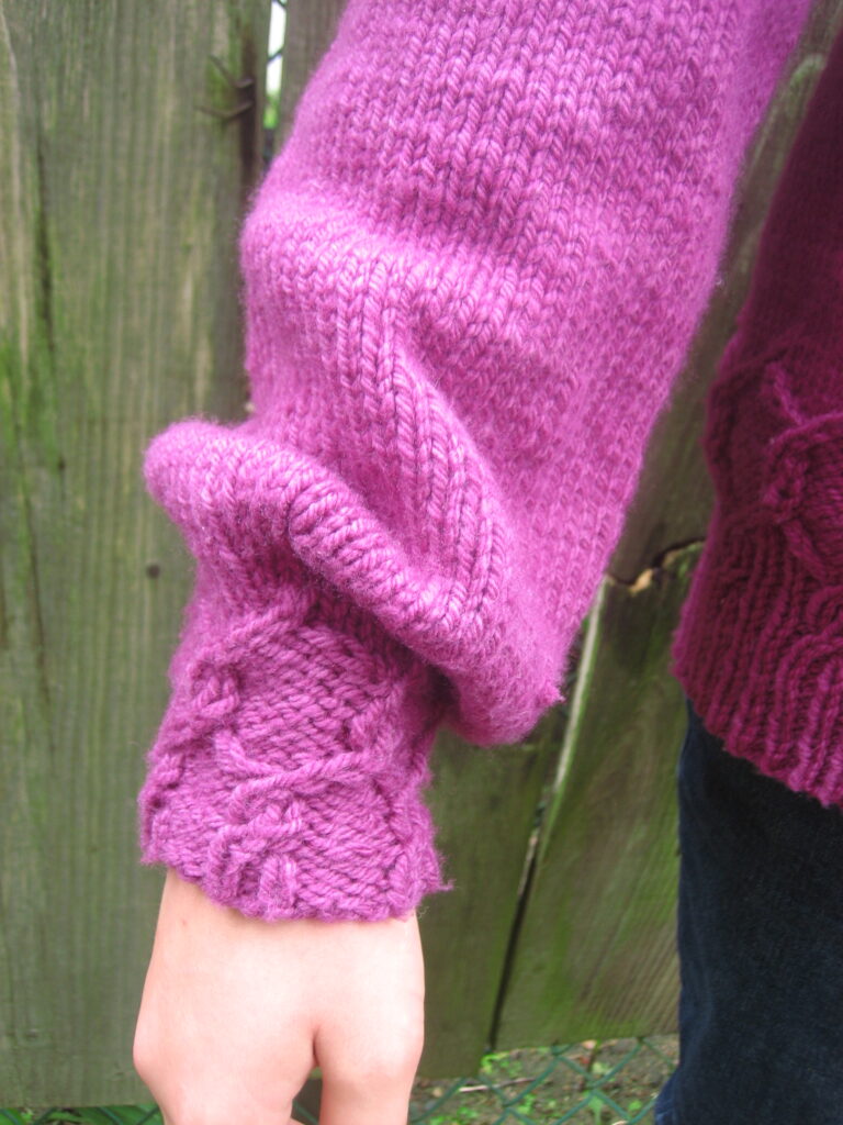 Cuff of Alcyone Sweater showing the hexagonal twist stitch. Photo by Christine Guest