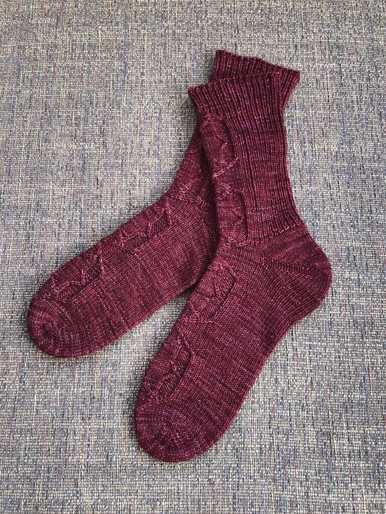 pair of Achird socks in plum knit my Moniek