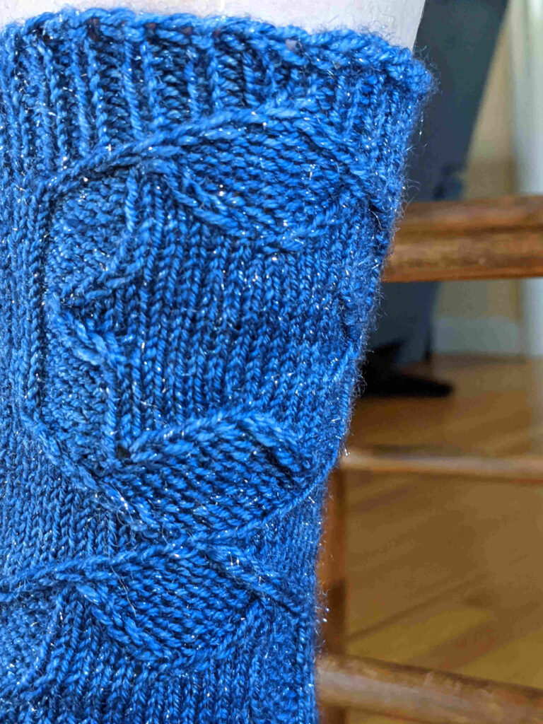 top of blue Achird socks showing how the hexagon frame blends into the ribbing