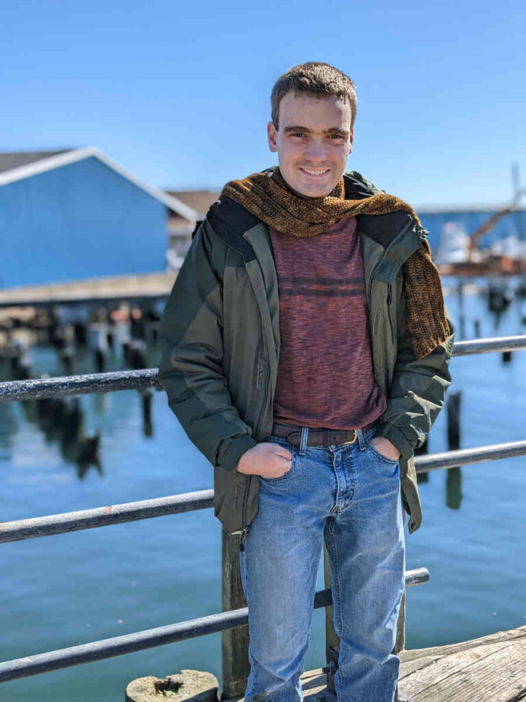 Newport Scarf modeled in front of railing at docks in Gloucester, MA