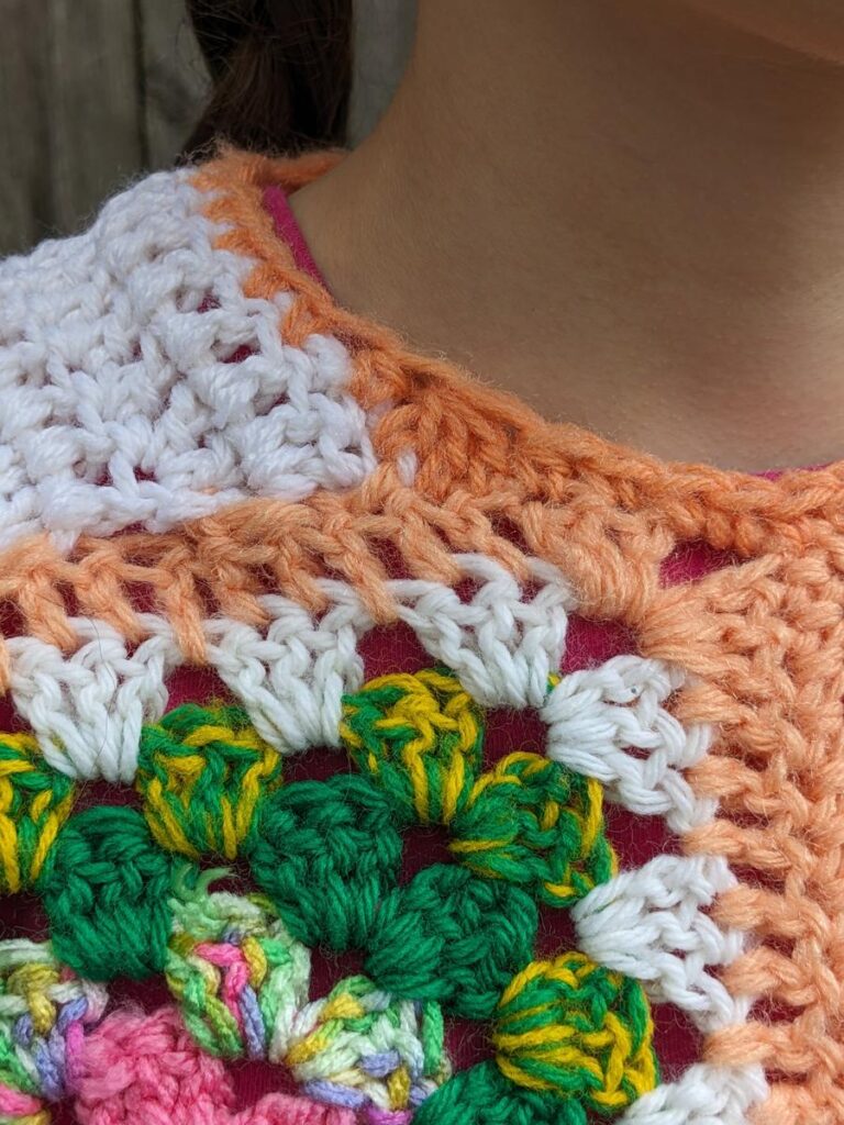 Closeup of neck curve using decreases and taller stitches in the corners