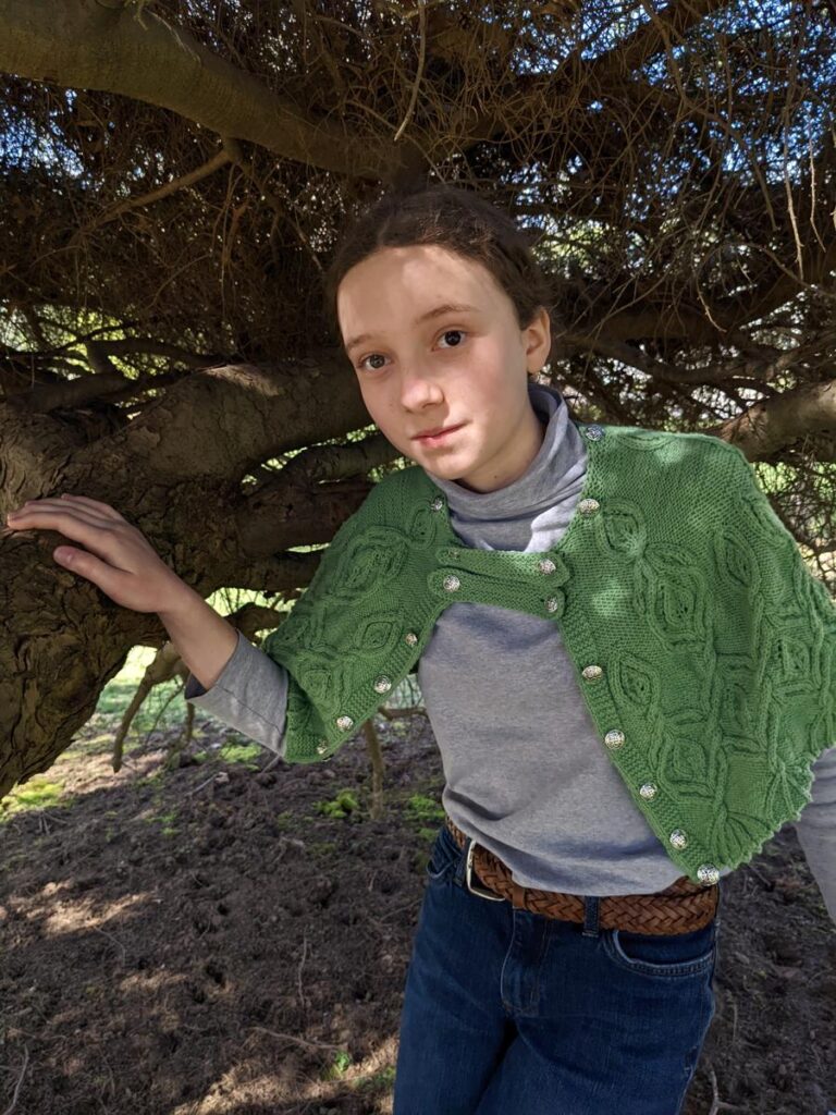 Girl under tree wears Silvia of ELF cape without the collar