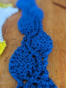 Crocus Petal Edging before folding, knit in cotton in a deep blue color